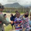 Personel Ops Damai Cartenz Berbagi Kebahagiaan Bersama Warga dan Anak-anak di Enarotali